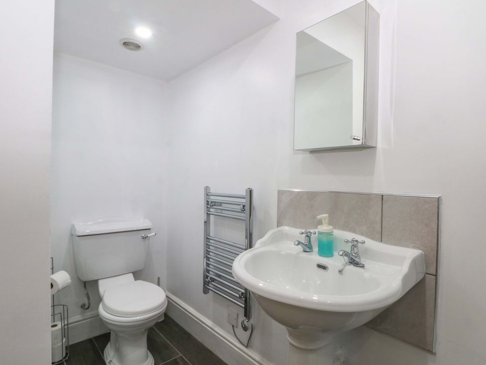 A bathroom with a toilet and sink at The Old Shippon