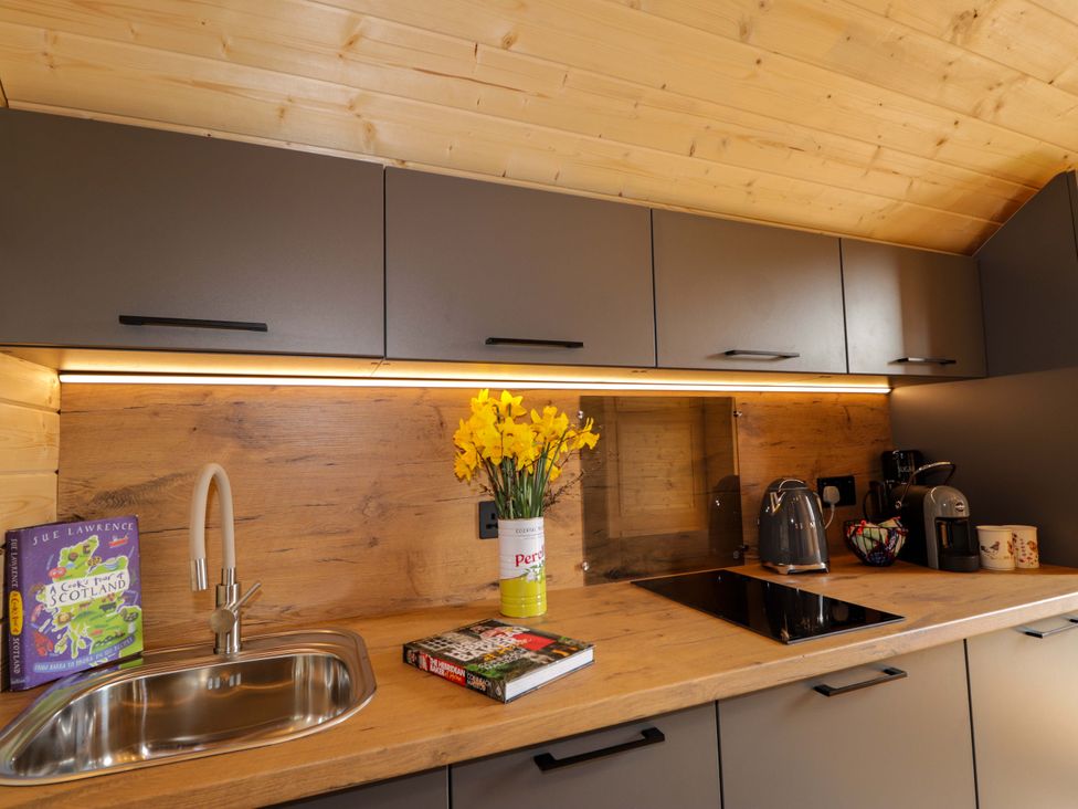 A kitchen with a sink, kettle, and coffee maker at Little Oaks in Poyntzfield near Cromarty