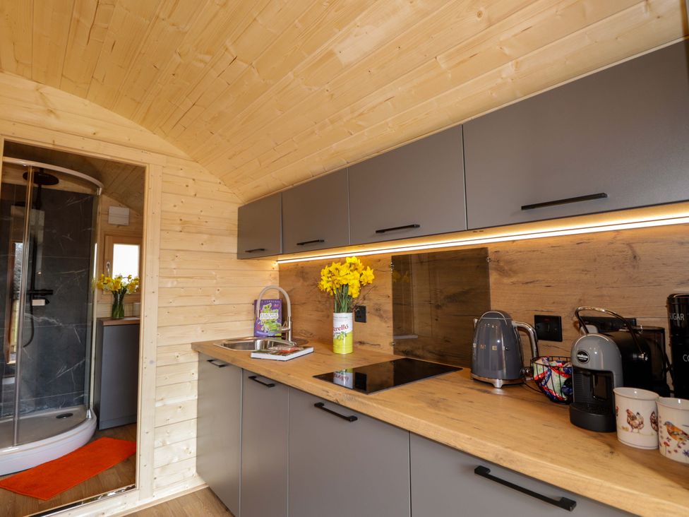 A kitchen with cabinets and appliances at Little Oaks in Poyntzfield near Cromarty