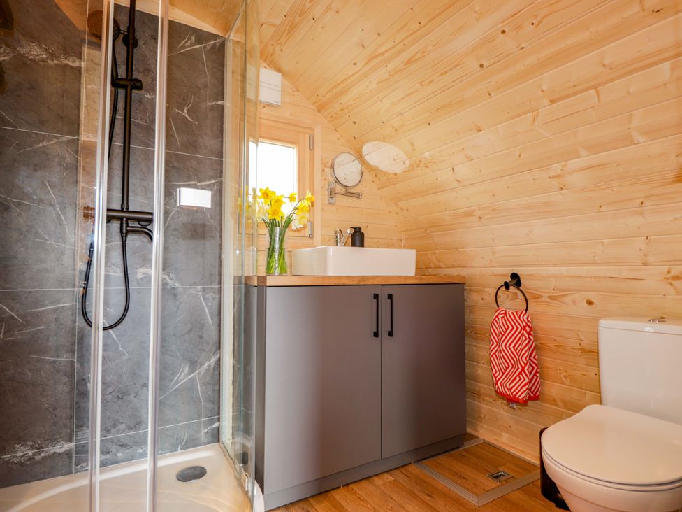 A bathroom with a shower and sink at Little Oaks in Poyntzfield near Cromarty