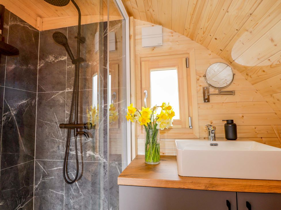 A bathroom with a shower and sink at Little Oaks in Poyntzfield near Cromarty