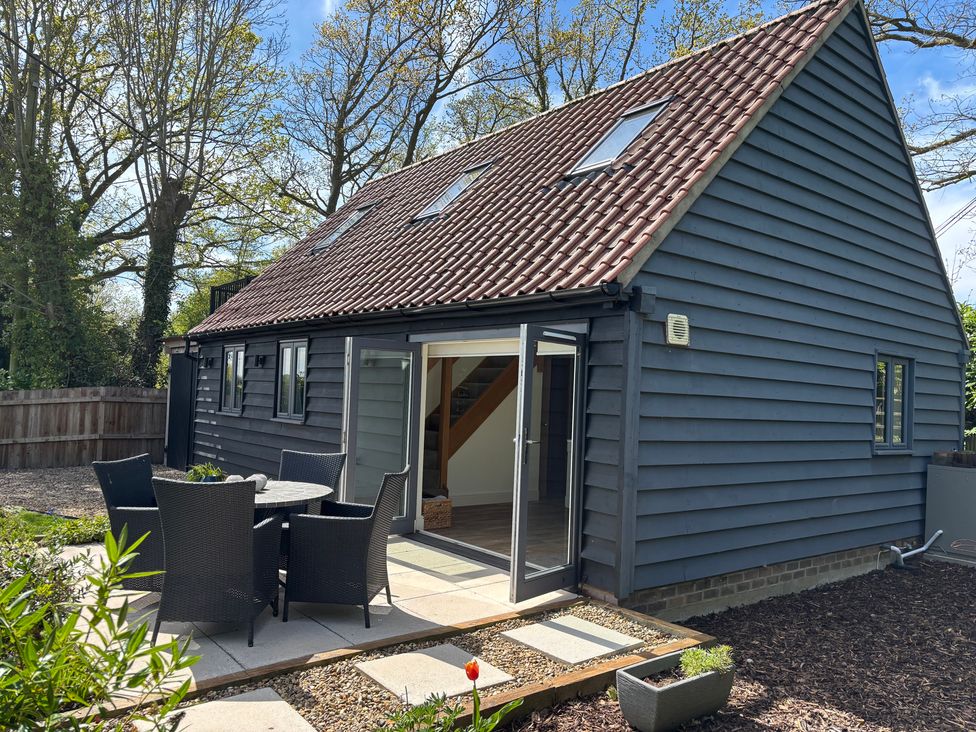 A house with a garden area and outdoor seating at Ash Tree Lodge in Norwich
