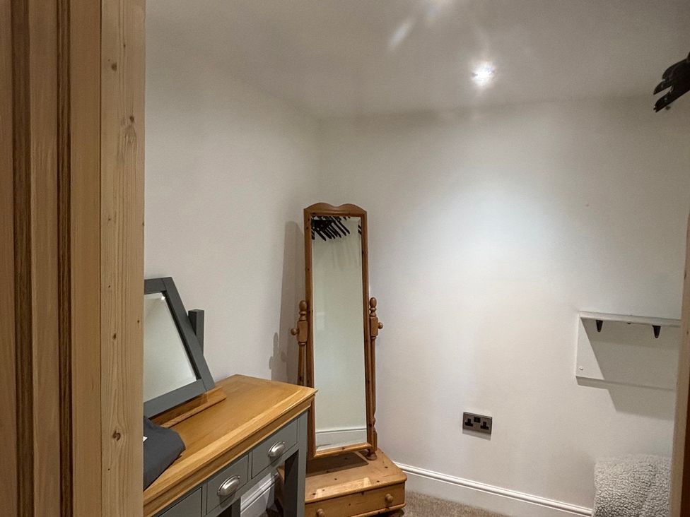 A dressing room with a mirror and a dresser at Ash Tree Lodge in Norwich