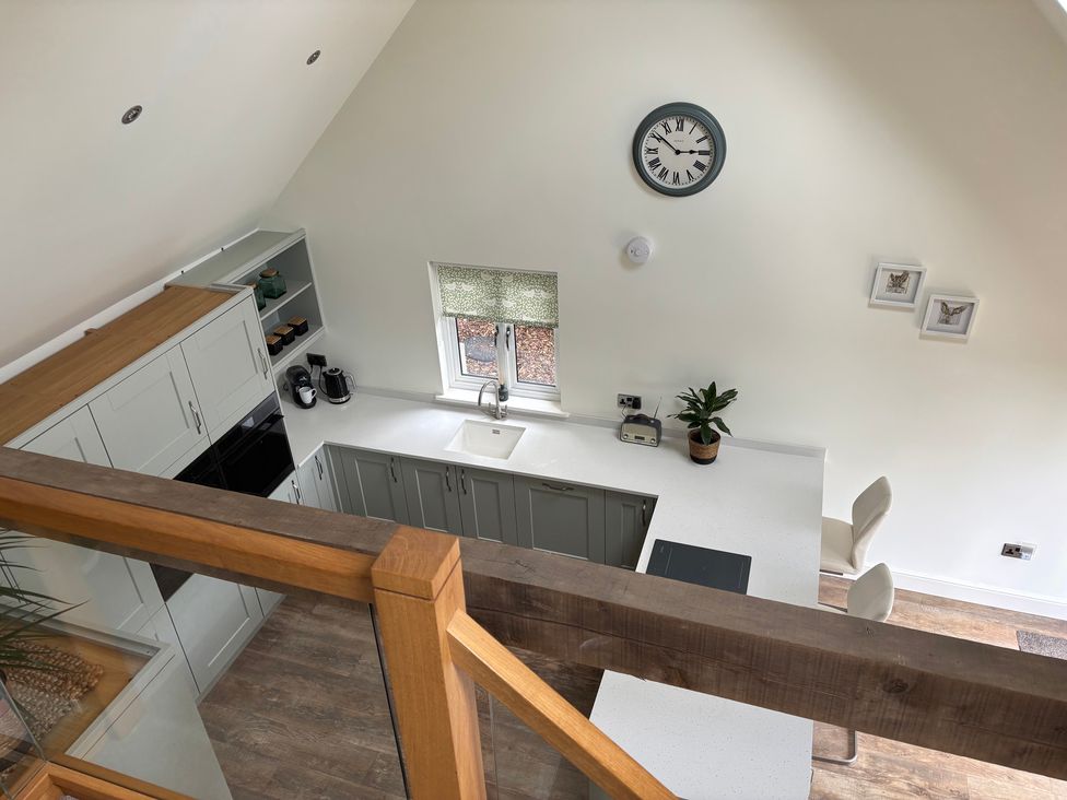 A kitchen with cabinets and a sink at Ash Tree Lodge in Carleton Rode