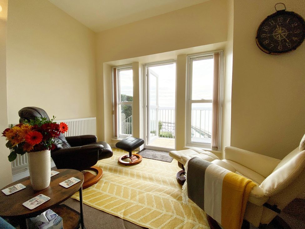 A living room with a recliner chair and a coffee table at Number 1 Marina Court in Torquay