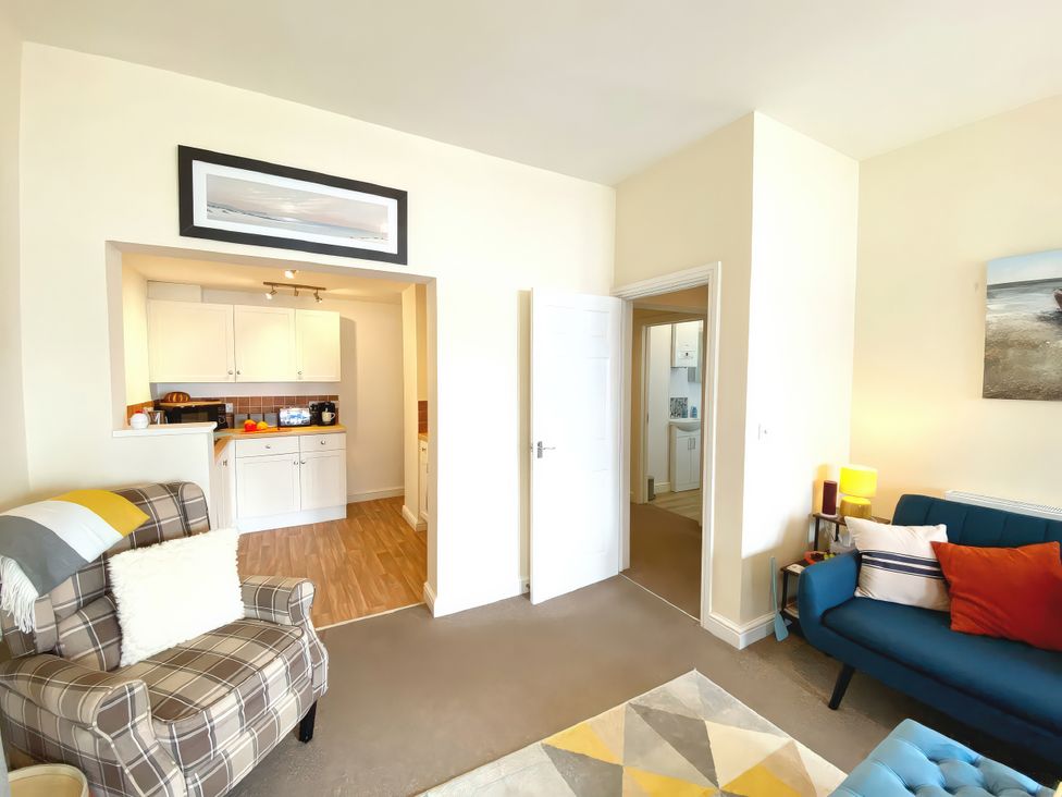 A living room with a sofa and armchair at Number 1 Marina Court in Torquay