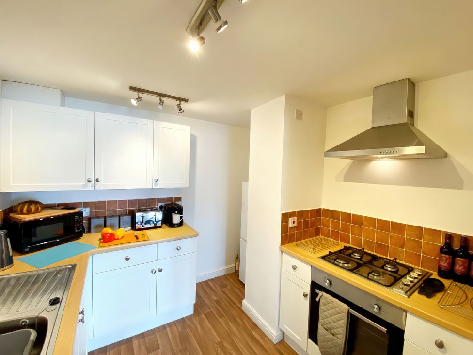 A kitchen with cabinets, countertop and appliances at Number 1 Marina Court in Torquay