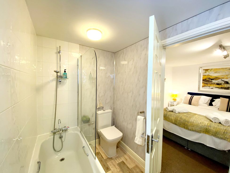 A bathroom with a bathtub and shower at Number 1 Marina Court in Torquay