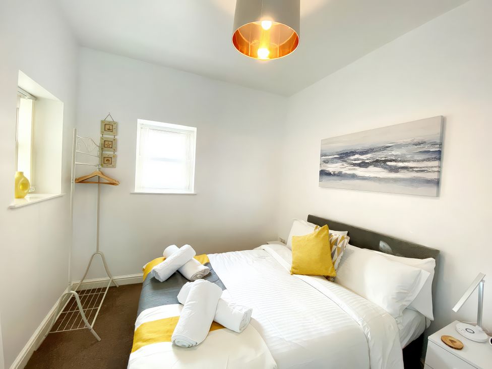 A bedroom with bed and a window at Number 1 Marina Court in Torquay