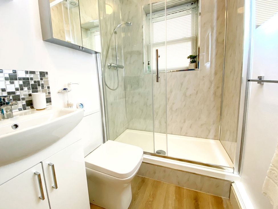 A bathroom with a shower and sink at Number 1 Marina Court in Torquay