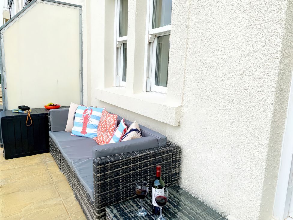 An outdoor area with a sofa and coffee table at Number 1 Marina Court in Torquay