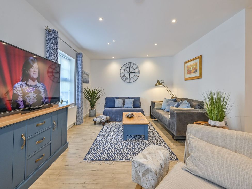 A living room with a sofa and television at Number 2 Ellington Court Apartment, Torquay