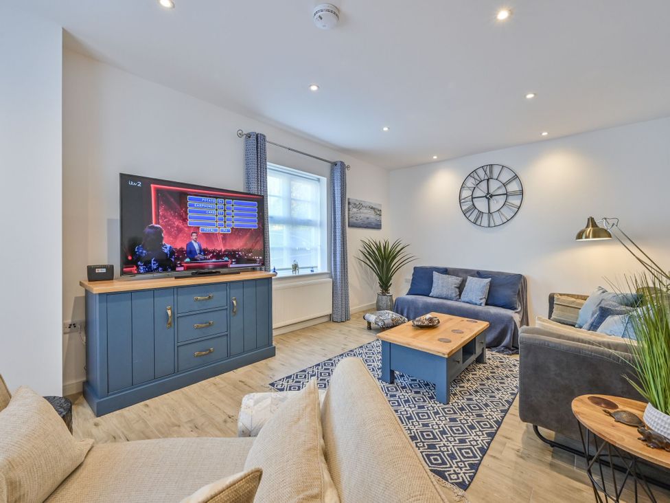 A living room with a television and a coffee table at Number 2 Ellington Court Apartment Torquay