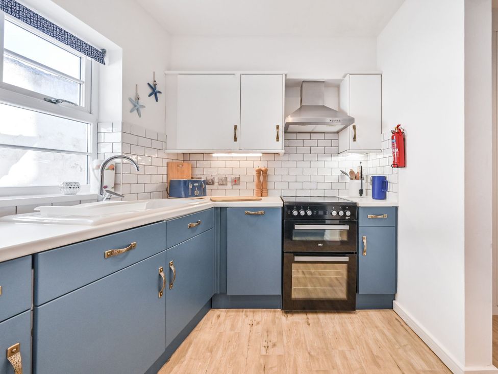 A kitchen with cabinets and appliances at Number 2 Ellington Court Apartment Torquay