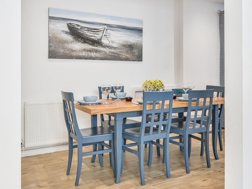A dining room with a table set for dinner at Number 2 Ellington Court Apartment in Torquay