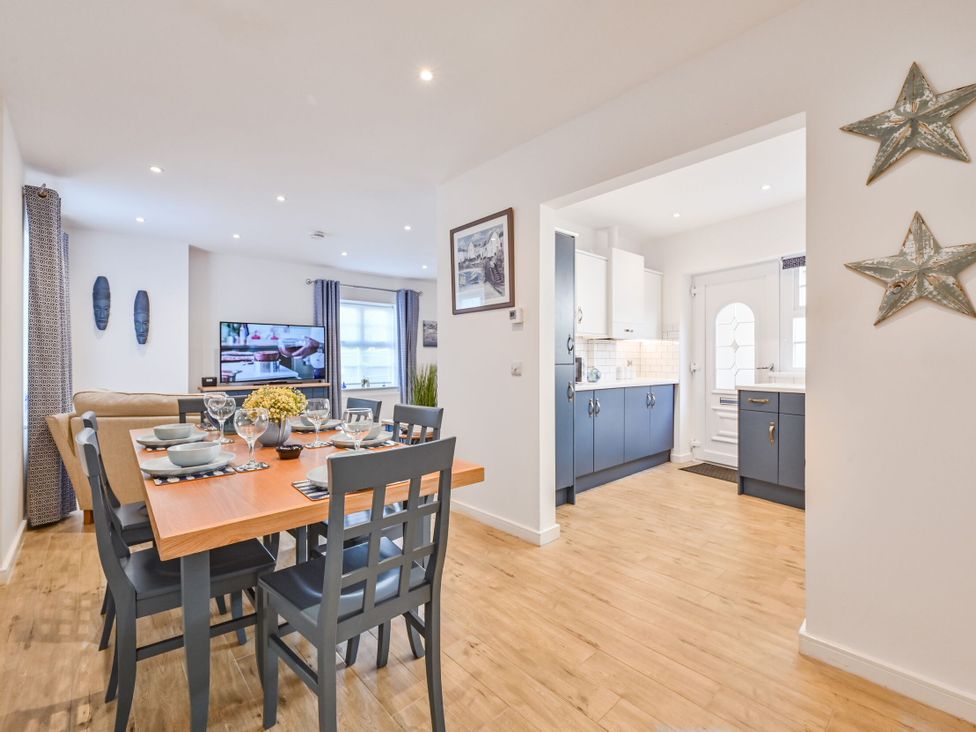 A dining room with a table and chairs at Number 2 Ellington Court Apartment in Torquay