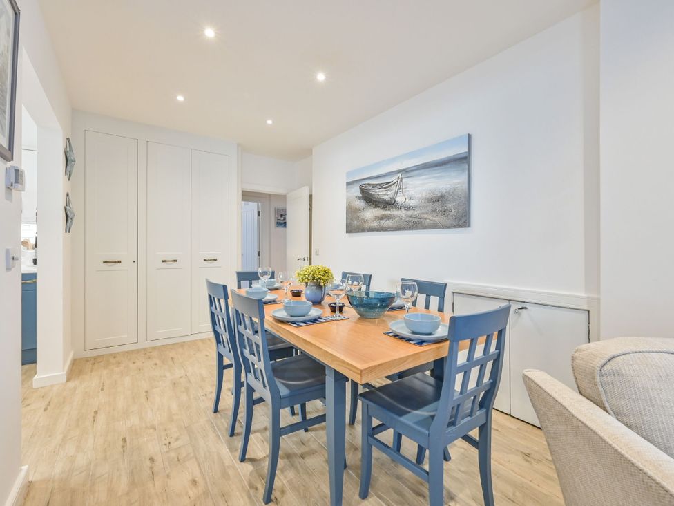 A dining room with a table set for a meal at Number 2 Ellington Court Apartment Torquay