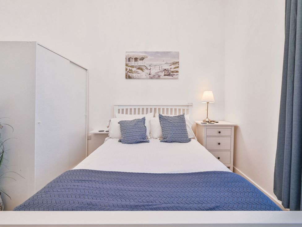 A bedroom with a bed and a bedside table at Number 2 Ellington Court Apartment Torquay