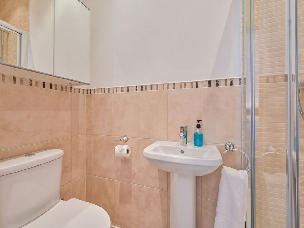 A bathroom with a toilet, sink, and shower at Number 2 Ellington Court Apartment Torquay