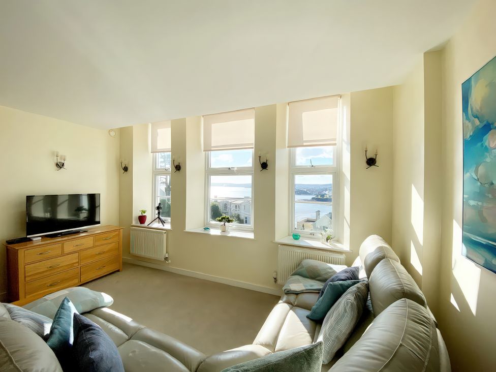 A living room with a television and a sofa at Sea View Apartment, Ellington Court in Torquay