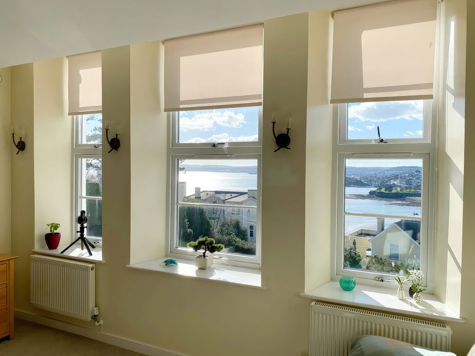A living room with windows and a view at Sea View Apartment, Ellington Court in Torquay