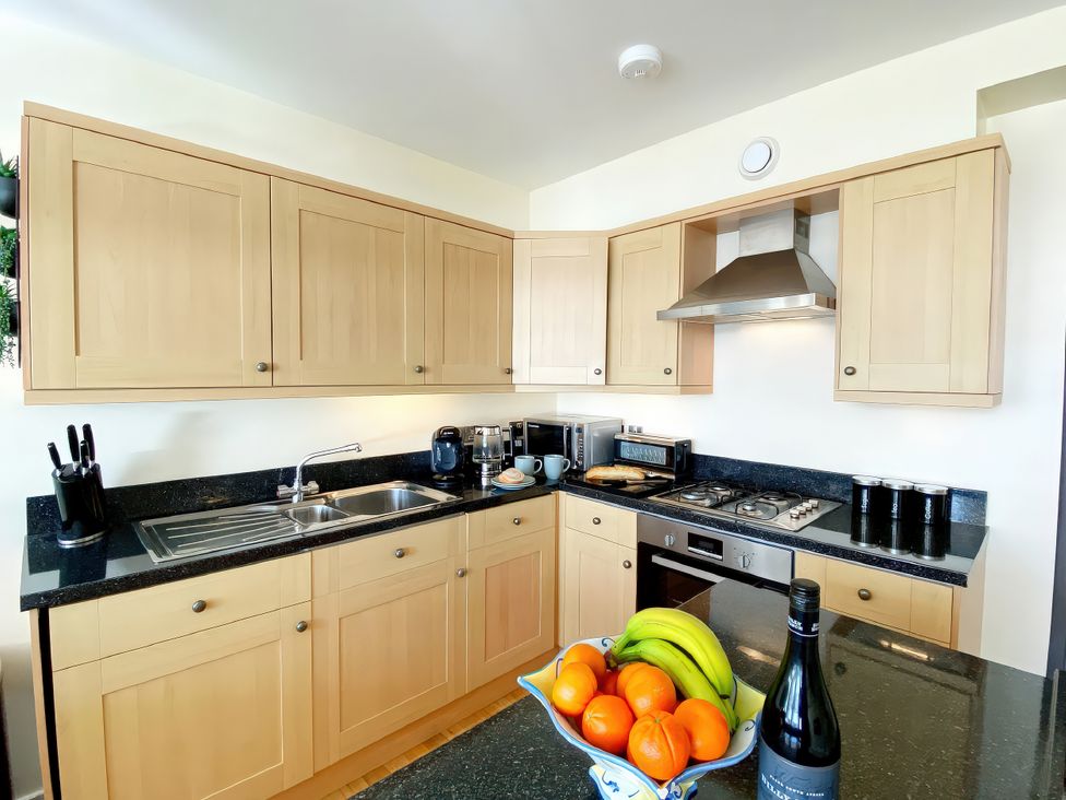 A kitchen with cabinets and appliances at Sea View Apartment, Ellington Court in Torquay