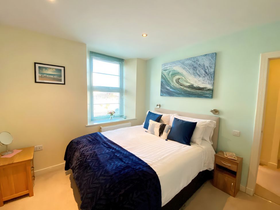 A bedroom with a bed and bedside table at Sea View Apartment, Ellington Court, Torquay