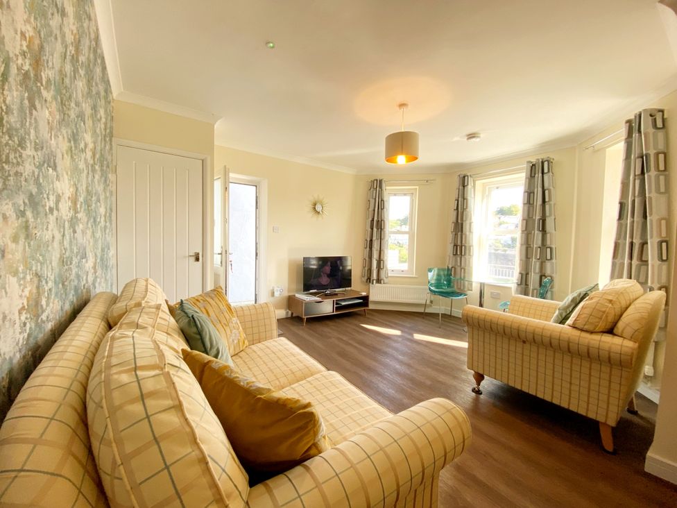 A living room with two sofas and a television at Ockedon House Apartment A Torquay
