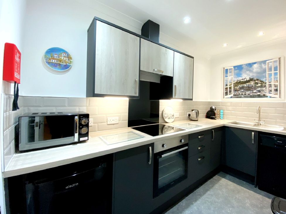 A kitchen with appliances and cabinetry at Ockedon House Apartment A Torquay