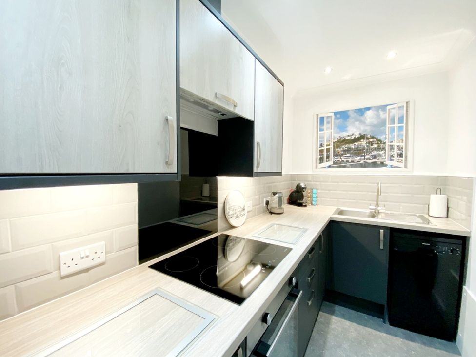 A kitchen with cabinets and appliances at Ockedon House Apartment A in Torquay