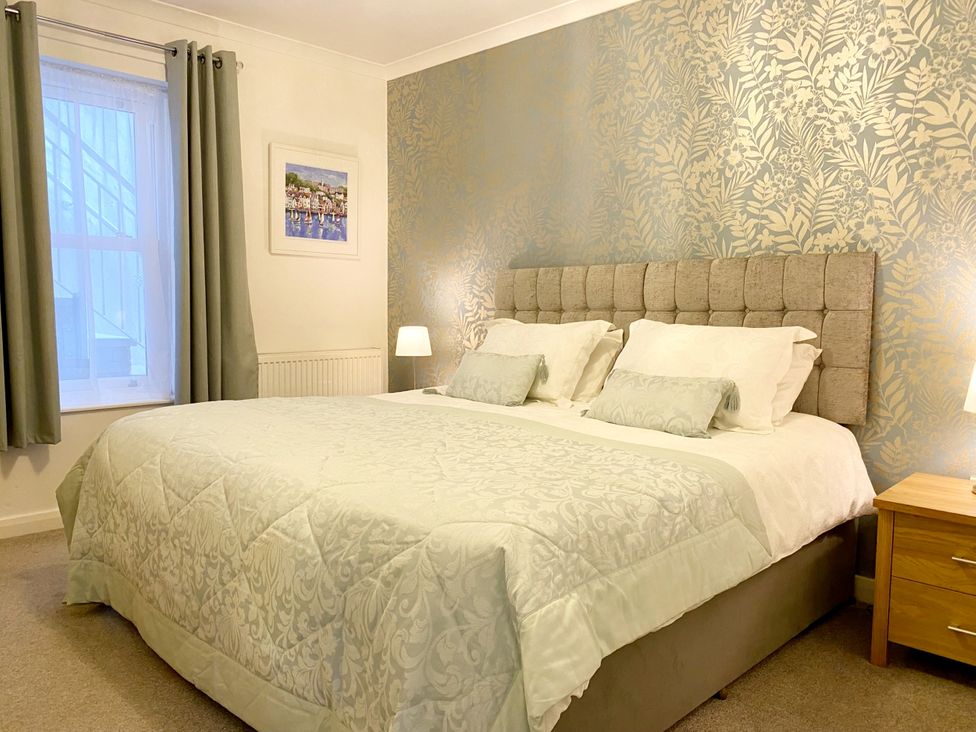 A bedroom with a bed and bedside table at Ockedon House Apartment A in Torquay