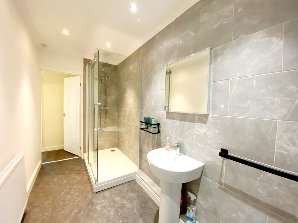 A bathroom with a shower and sink at Ockedon House Apartment A in Torquay