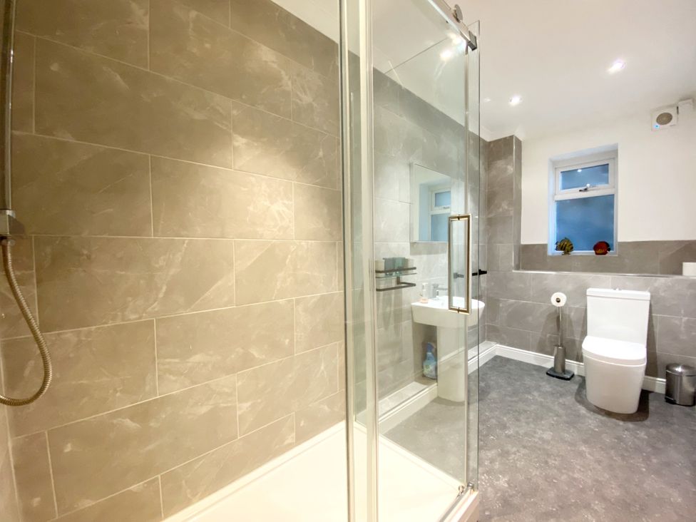 A bathroom with shower, toilet and sink at Ockedon House Apartment A, Torquay
