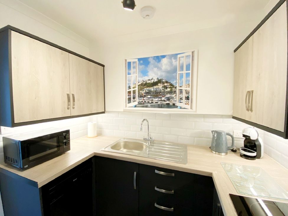 A kitchen with a sink and appliances at Ockendon House Apartment B Torquay