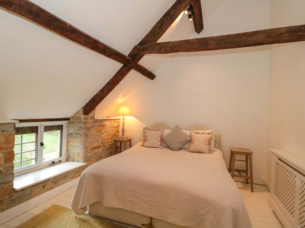 A bedroom with a bed and lamp at The Farmhouse in Langport
