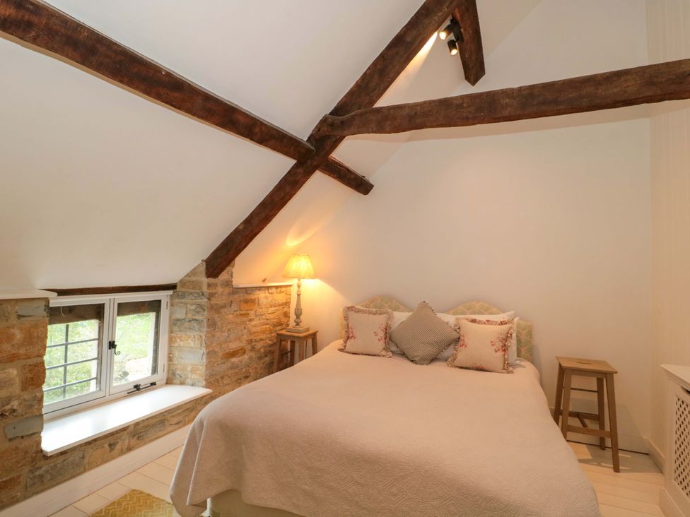 A bedroom with a bed and window at The Farmhouse in Langport