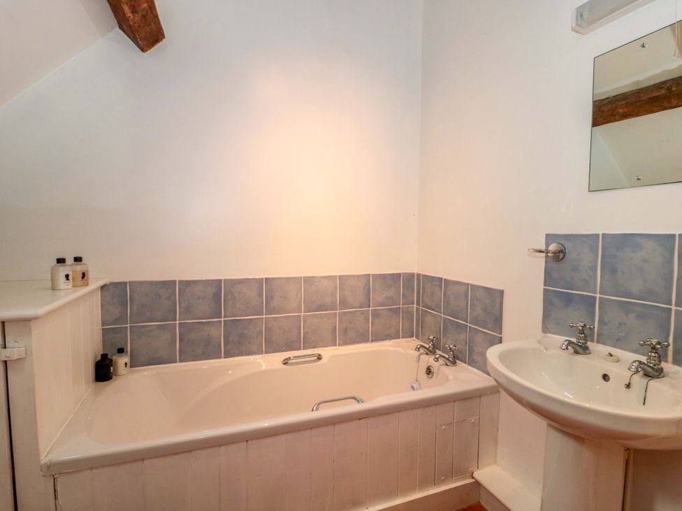 A bathroom featuring a bathtub and sink at The Farmhouse in Langport