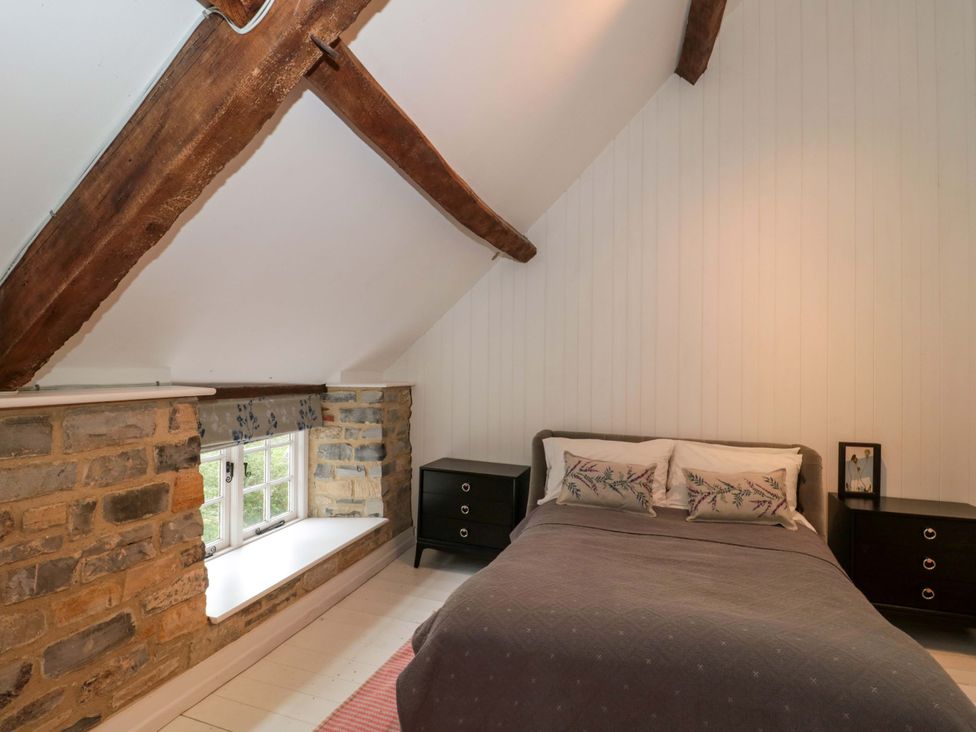 A bedroom with a bed and nightstands at The Farmhouse in Langport