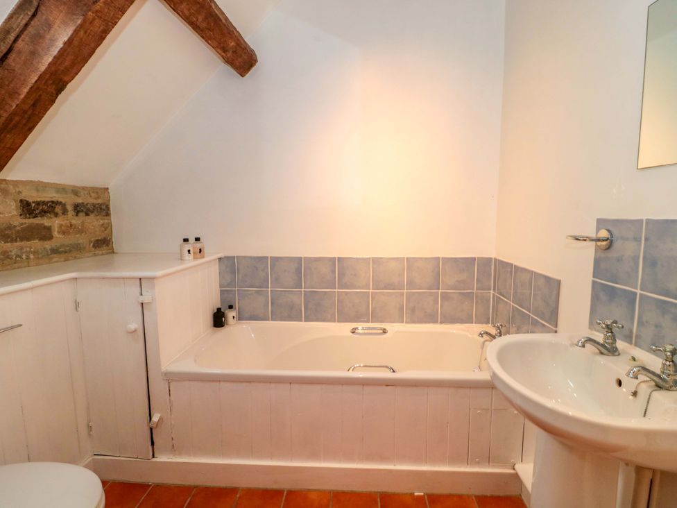 A bathroom with a bath tub and sink at The Farmhouse in Langport