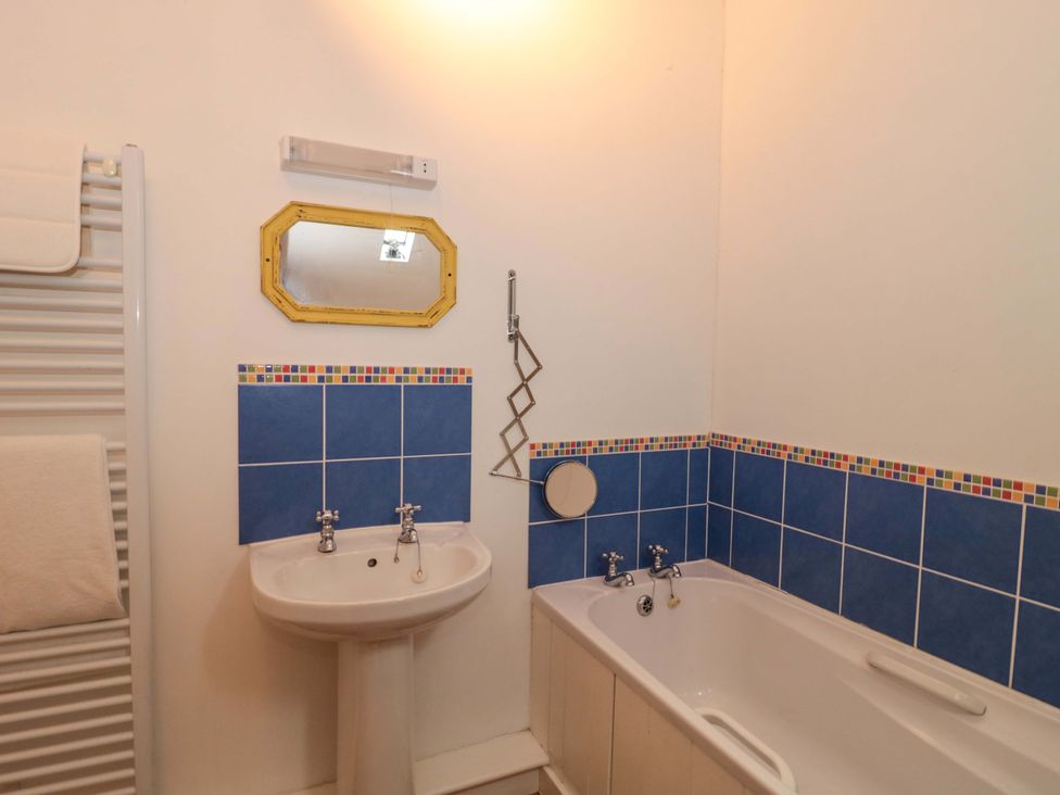 A bathroom with a bath and a sink at The Farmhouse in Langport