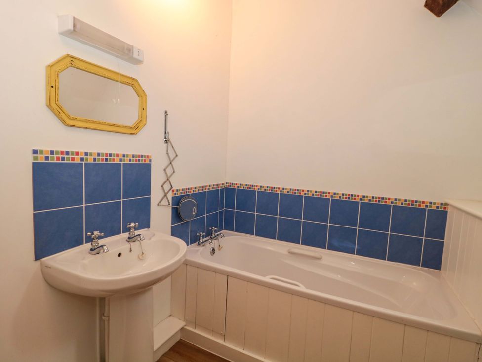 A bathroom with a sink and bathtub at The Farmhouse in Langport