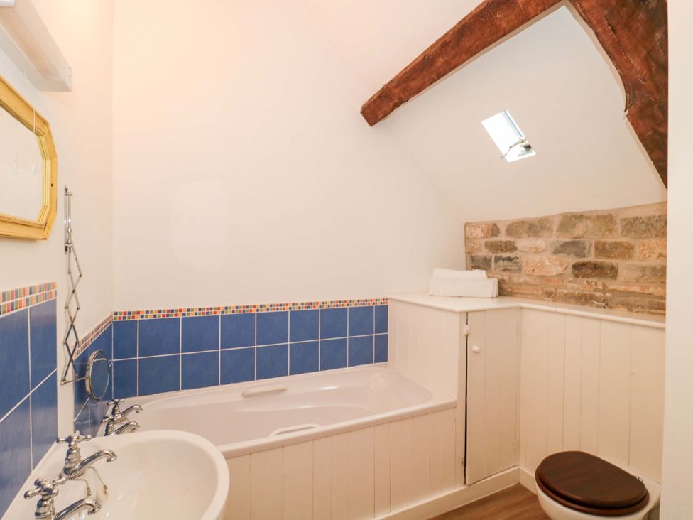A bathroom with a bathtub and sink at The Farmhouse in Langport