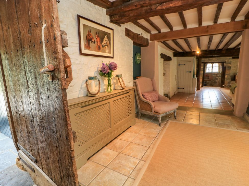 A hallway with a console table and flowers at The Farmhouse in Langport