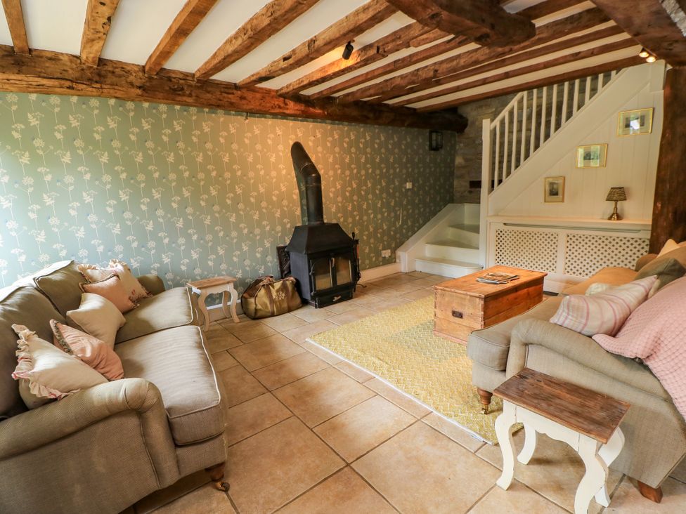 A living room with a sofa and fireplace at The Farmhouse in Langport
