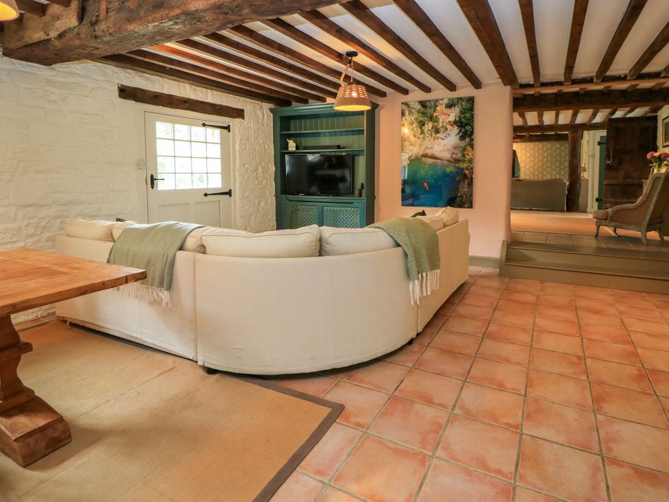 A living room with a sofa and table at The Farmhouse in Langport