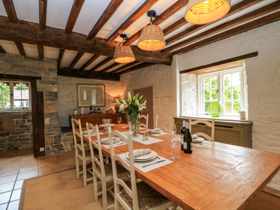 A dining room with a large table and chairs at The Farmhouse in Langport