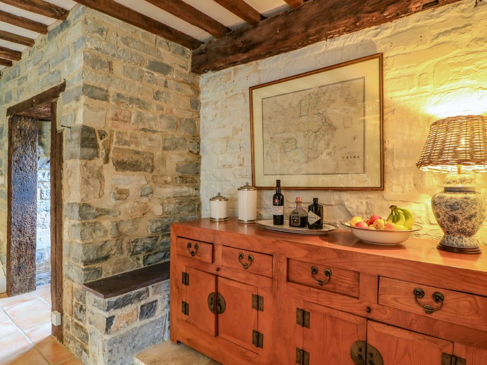 An entryway with a stone wall and console table at The Farmhouse in Langport