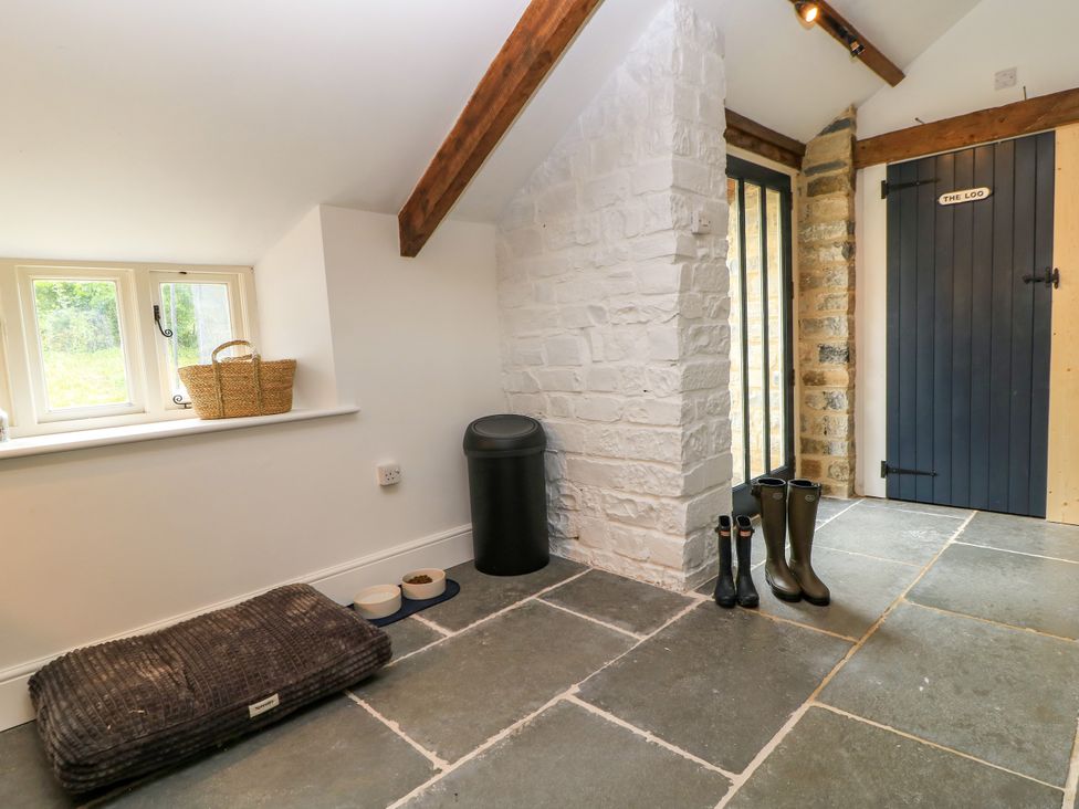 An entrance hall with a door and window at The Farmhouse in Langport