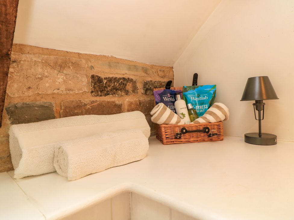 Towels and bath products on a countertop at The Farmhouse in Langport