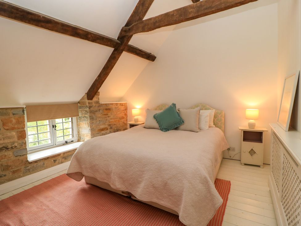 A bedroom with a bed and lamps at The Farmhouse in Langport